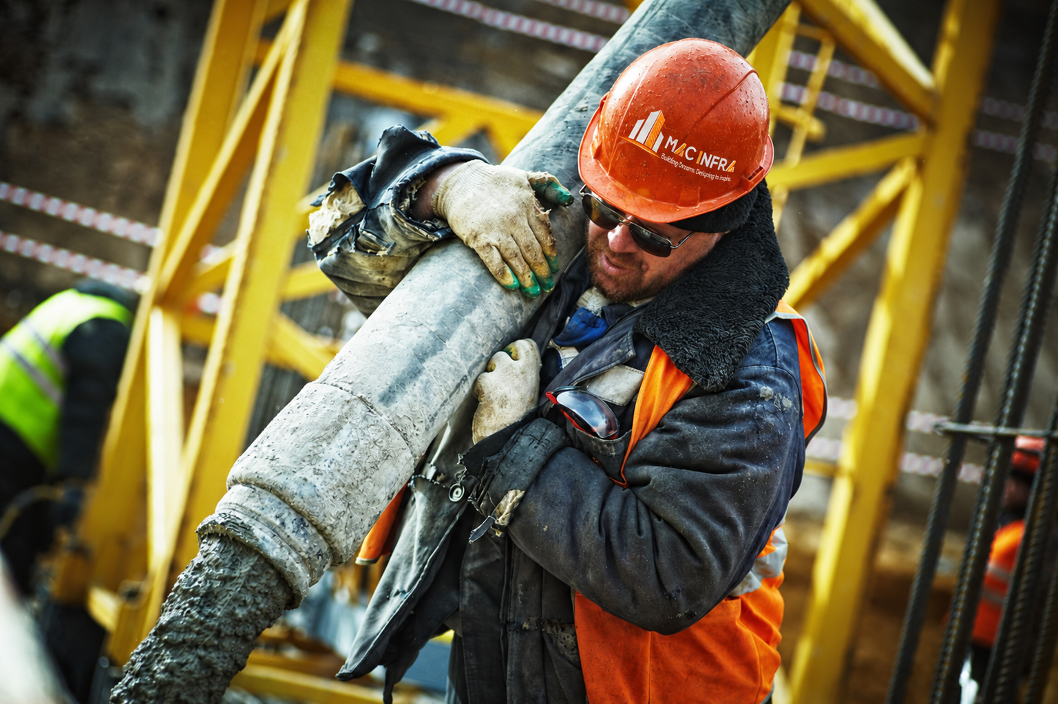 Construction worker placing concrete on site